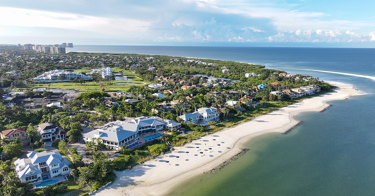 Aerial view of Hideaway Beach Club with private beach, homes, and Gulf shoreline