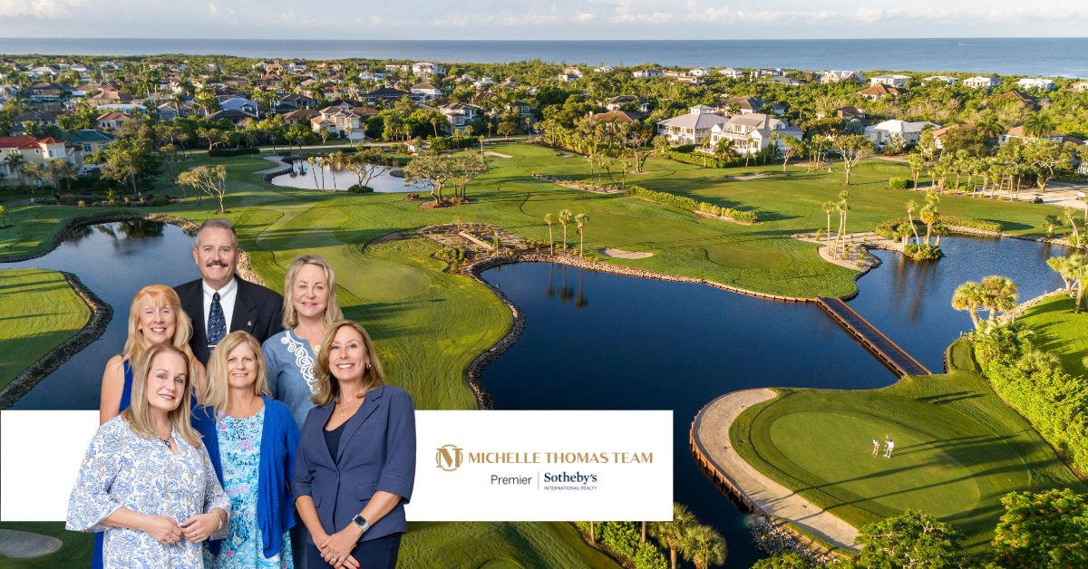 Group portrait of the Michelle Thomas Team standing on a golf course