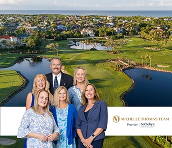 Group portrait of the Michelle Thomas Team standing on a golf course
