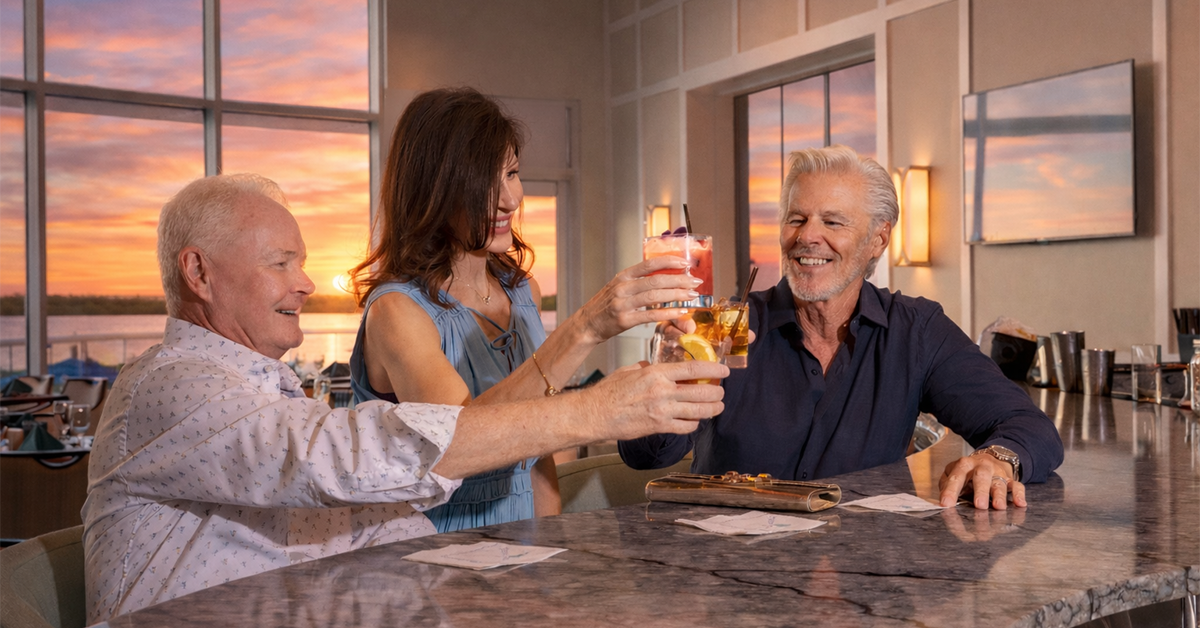 Friends raising drinks together at a bar.