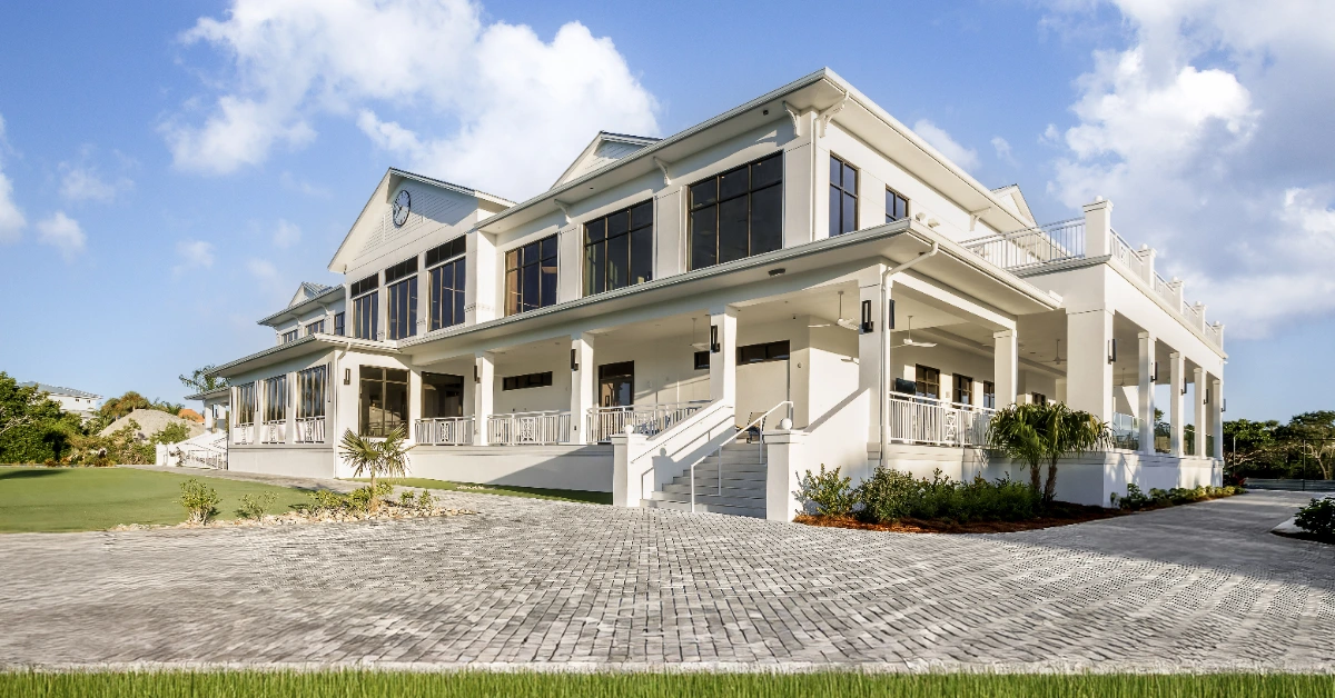 Coastal clubhouse exterior with columns and covered terrace